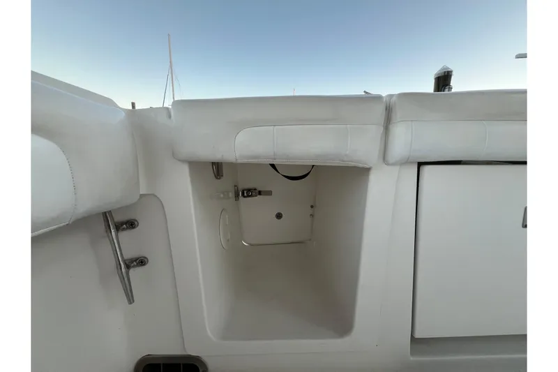 Slide: The Image of 2018 Regulator 28 boat storage compartment with white interior and seating. - 9