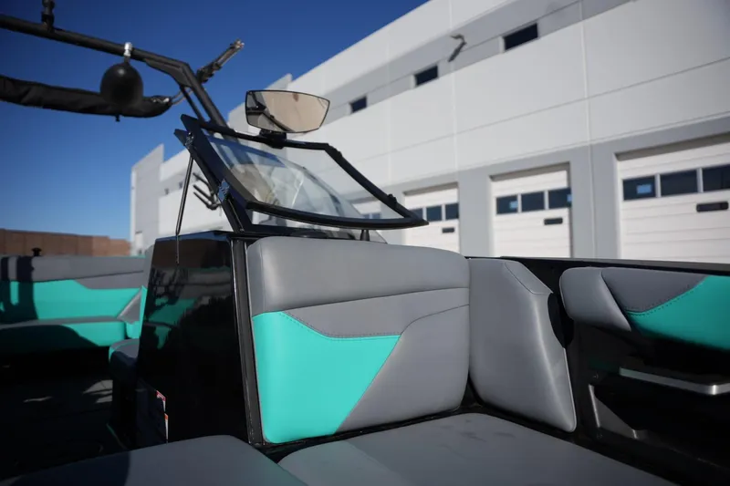 Slide: The Image of 2023 Axis A20 boat interior with teal and gray seating, modern design. - 10