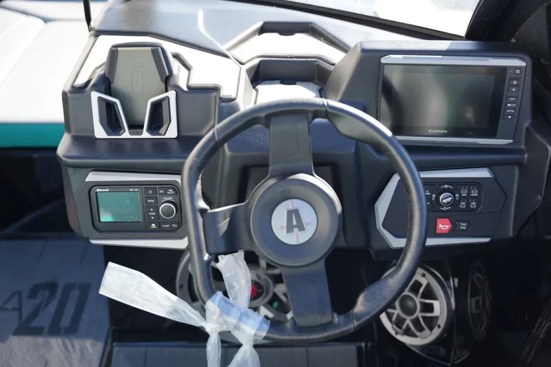 Slide: The Image of 2023 Axis A20 boat dashboard with steering wheel and electronic controls. - 11