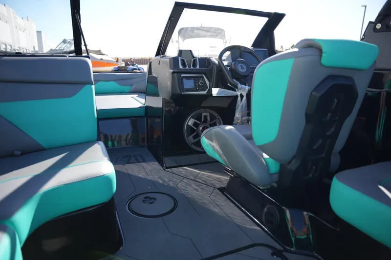 Slide: The Image of 2023 Axis A20 boat interior with teal and gray seating, modern dashboard, and steering wheel. - 16