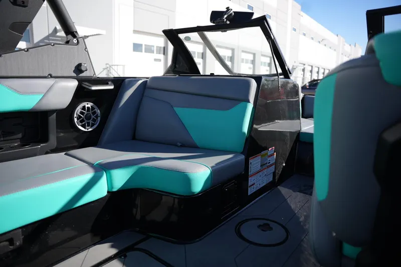 Slide: The Image of 2023 Axis A20 boat interior with teal and gray seating, modern design. - 17
