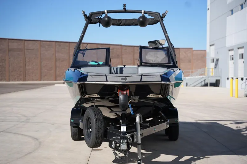 Slide: The Image of 2023 Axis A20 boat on trailer, parked outdoors in a sunny setting. - 7