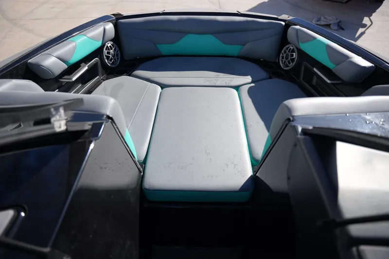 Slide: The Image of 2023 Axis A20 boat interior with gray and teal seating, featuring built-in speakers. - 9