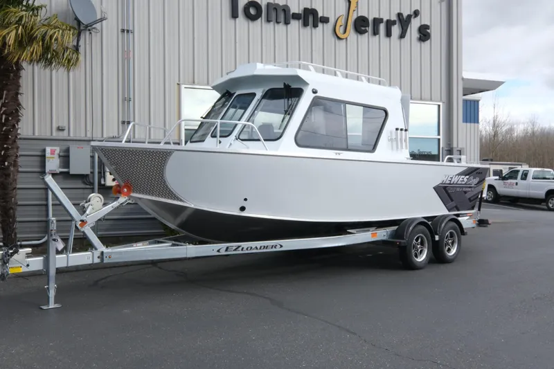 The Image of 2026 Hewescraft 210 Sea Runner ET Hardtop boat on trailer outside dealership. - 1