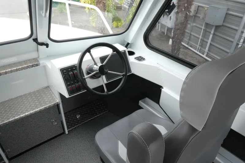 Slide: The Image of Interior of 2026 Hewescraft 210 Sea Runner ET Hardtop, featuring steering wheel and controls. - 13