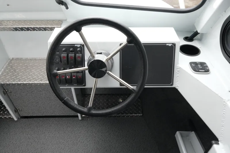 Slide: The Image of Steering wheel and control panel of 2026 Hewescraft 210 Sea Runner ET Hardtop boat. - 14
