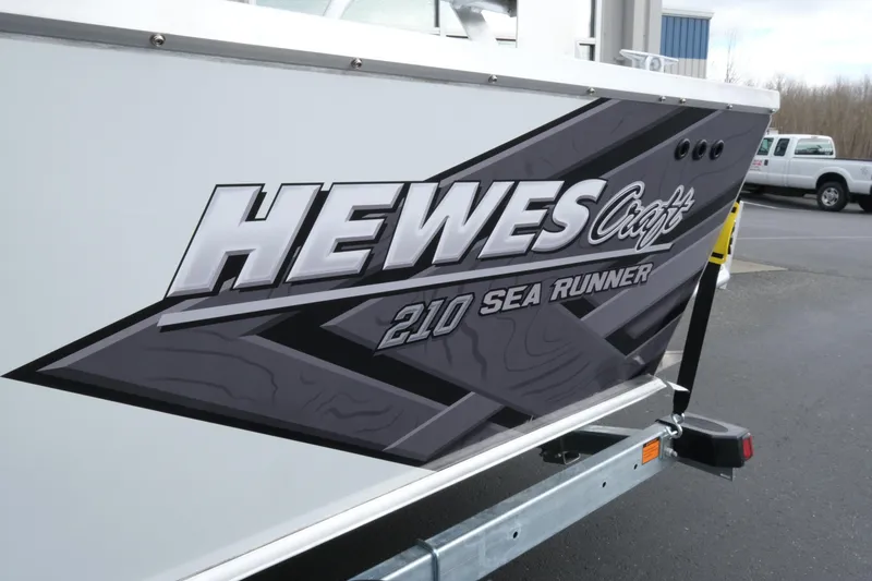 Slide: The Image of 2026 Hewescraft 210 Sea Runner ET Hardtop boat decal on trailer. - 6
