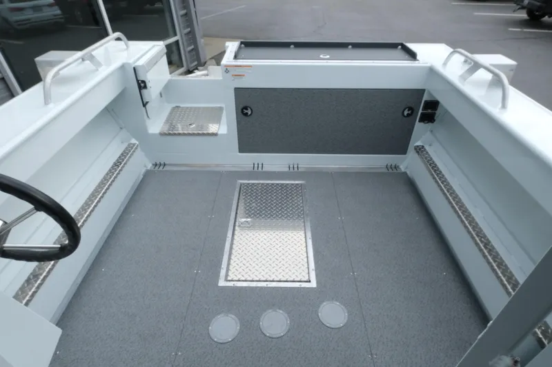 Slide: The Image of Interior of 2026 Hewescraft 210 Sea Runner ET Hardtop boat, featuring spacious deck and storage. - 8