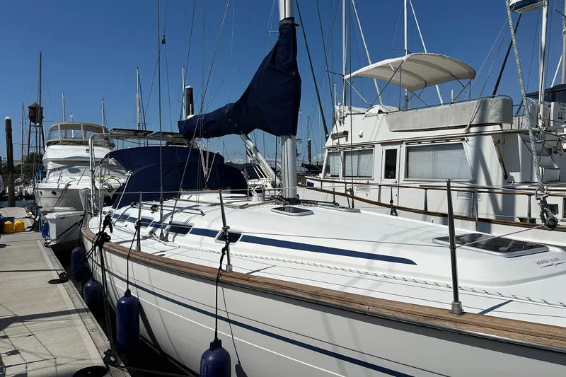 Slide: The Image of 2003 Bavaria 44 sailboat docked at marina under clear blue sky. - 1
