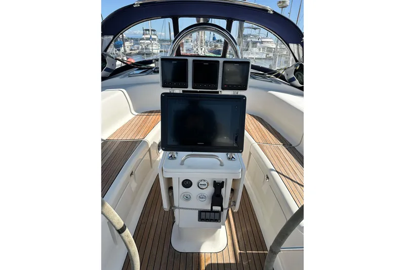 Slide: The Image of Cockpit of 2003 Bavaria 44 sailboat with navigation instruments and wooden deck. - 12