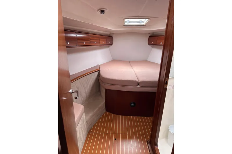 Slide: The Image of Cozy cabin interior of 2003 Bavaria 44 yacht with wood finish and comfortable bedding. - 14