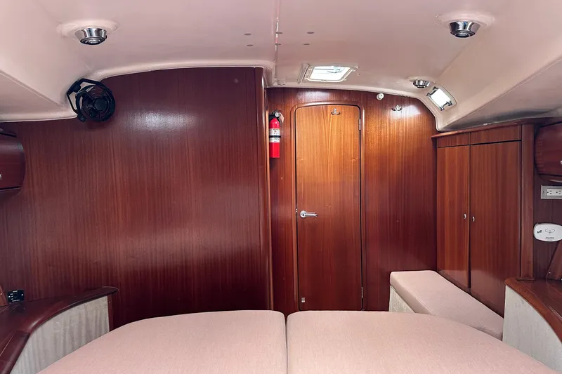 Slide: The Image of Interior of a 2003 Bavaria 44 yacht with wooden paneling and cozy furnishings. - 15