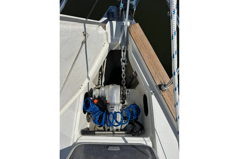 Slide: The Image of Anchor winch system on a 2003 Bavaria 44 sailboat, featuring coiled blue hose. - 19