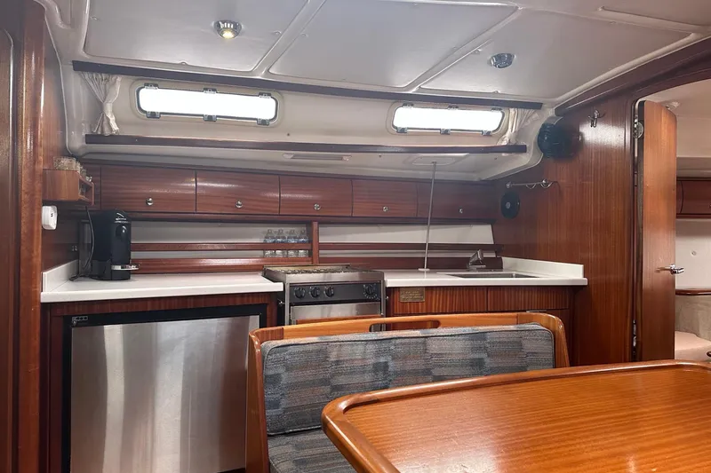 Slide: The Image of Interior of 2003 Bavaria 44 yacht kitchen with wood cabinetry and modern appliances. - 22