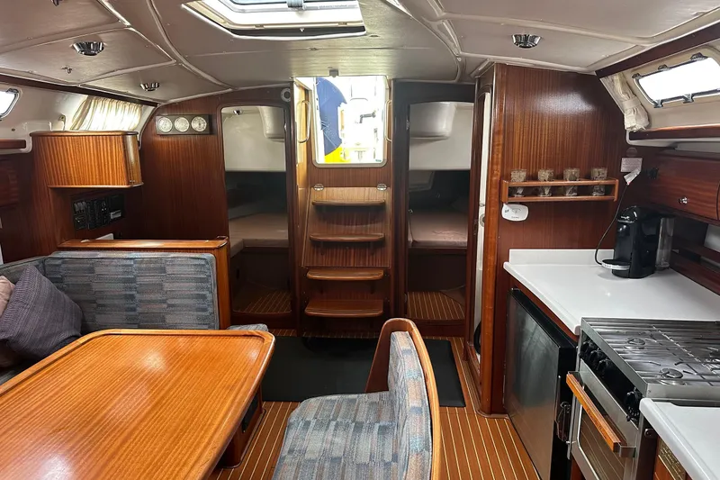 Slide: The Image of Interior of a 2003 Bavaria 44 yacht with wood finish and modern amenities. - 28