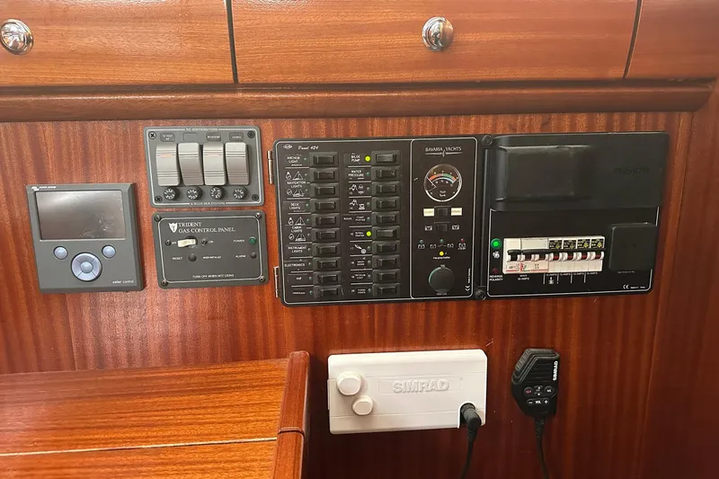 Slide: The Image of Control panel of a 2003 Bavaria 44 yacht with various switches and gauges. - 30