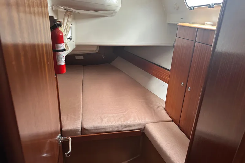 Slide: The Image of Interior cabin of 2003 Bavaria 44 sailboat with bed and wooden cabinetry. - 32