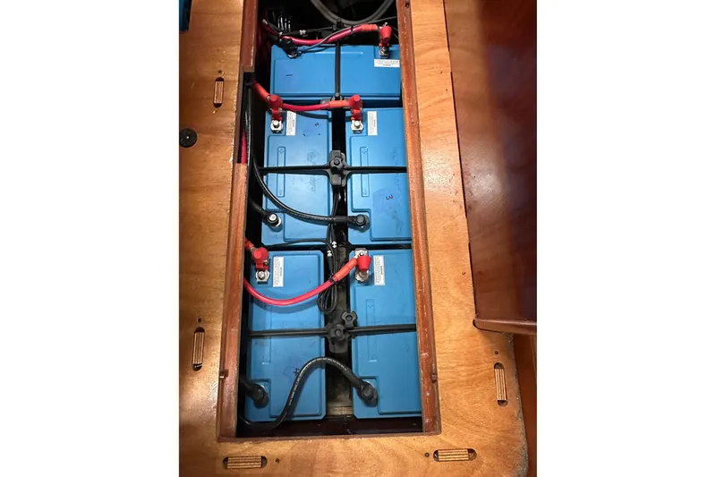 Slide: The Image of Battery compartment of a 2003 Bavaria 44 yacht, featuring multiple blue batteries. - 35