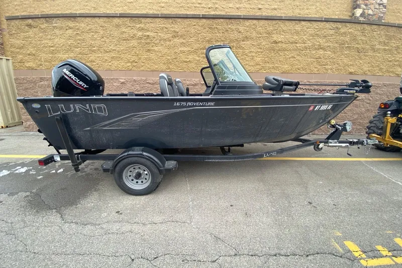 Slide: The Image of 2022 Lund 1675 Adventure Sport boat on trailer, parked outdoors. - 1