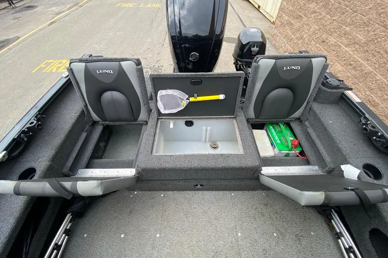 Slide: The Image of 2022 Lund 1675 Adventure Sport boat interior with storage compartments and seating. - 12