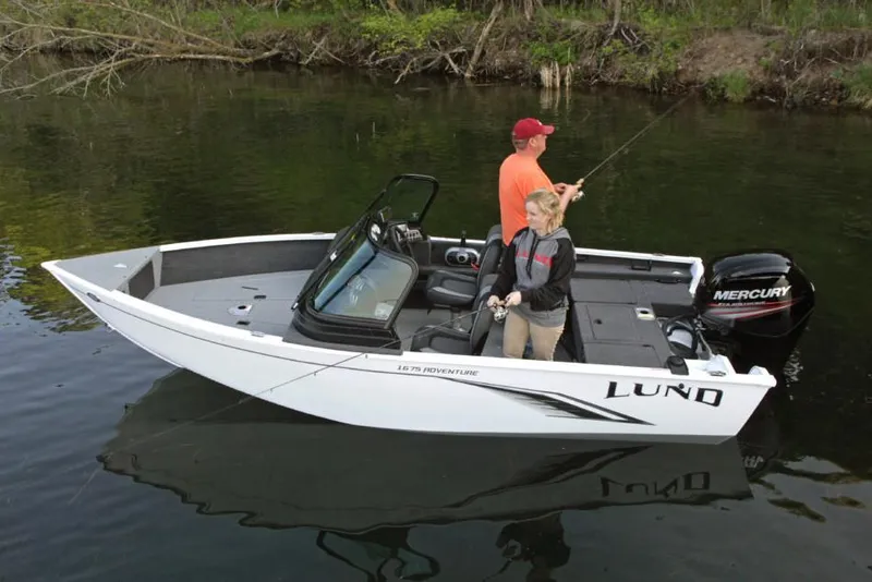 Slide: The Image of Manufacturer Provided Image: 2022 Lund 1675 Adventure Sport boat with two people fishing on a calm lake. - 19
