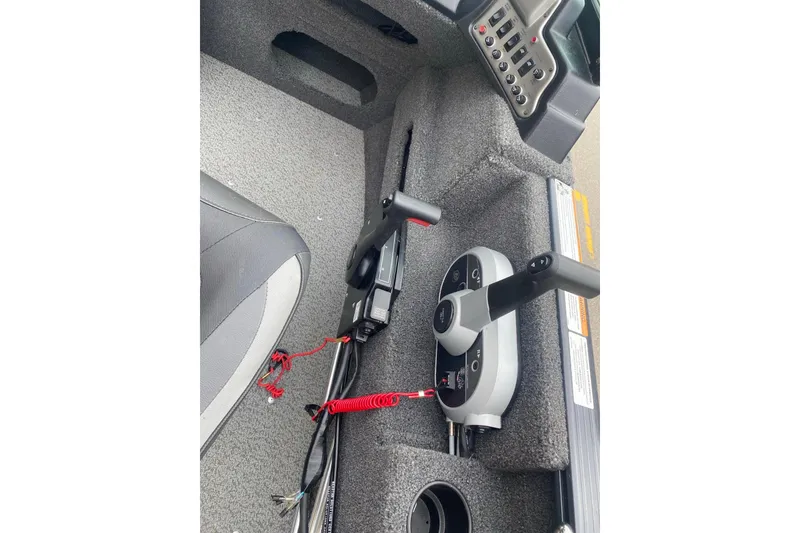 Slide: The Image of 2022 Lund 1675 Adventure Sport boat interior with control panel and seating. - 4