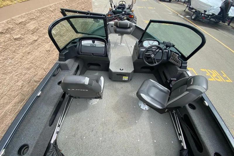 Slide: The Image of 2022 Lund 1675 Adventure Sport boat interior with seating and steering console. - 5