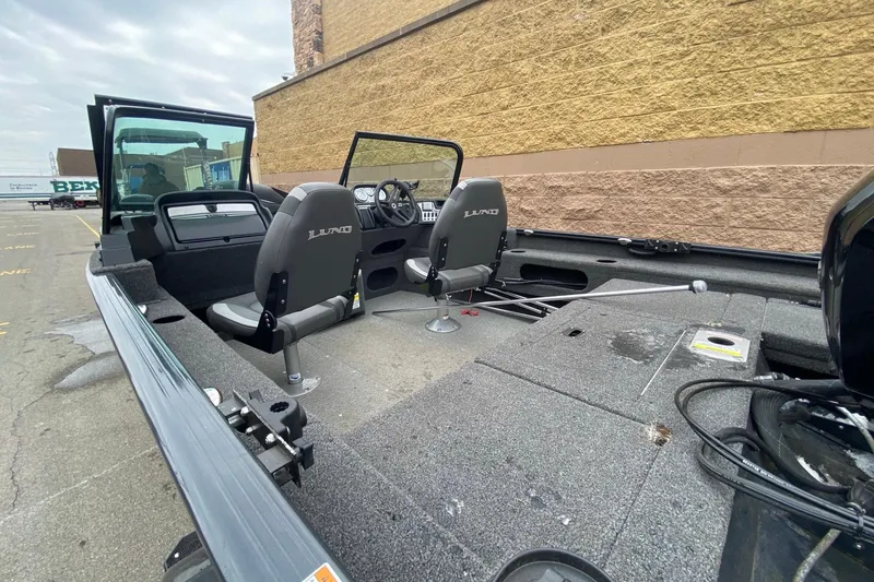 Slide: The Image of 2022 Lund 1675 Adventure Sport boat interior with seating and steering console. - 6