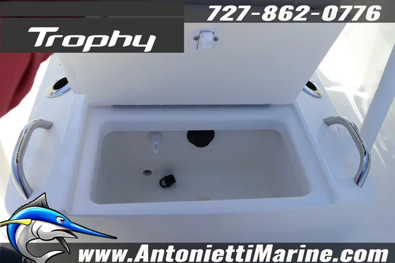 Slide: The Image of 2026 Bayliner Trophy T18 boat interior with storage compartment, featuring handles and branding. - 11