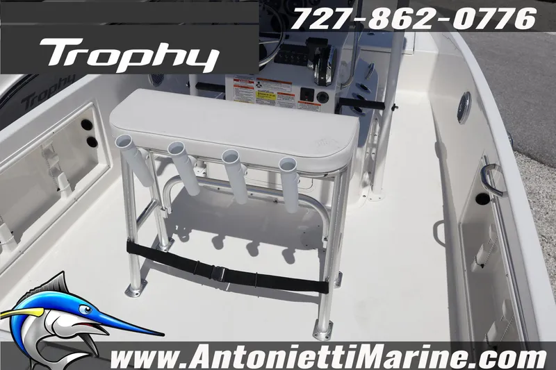 Slide: The Image of 2026 Bayliner Trophy T18 boat interior with rod holders and console details. - 13