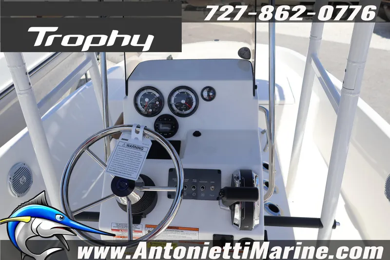 Slide: The Image of 2026 Bayliner Trophy T18 boat dashboard with steering wheel and controls. - 6