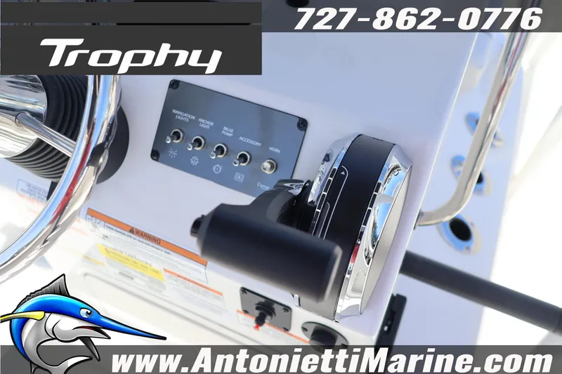 Slide: The Image of 2026 Bayliner Trophy T18 boat control panel with steering wheel and throttle. - 7