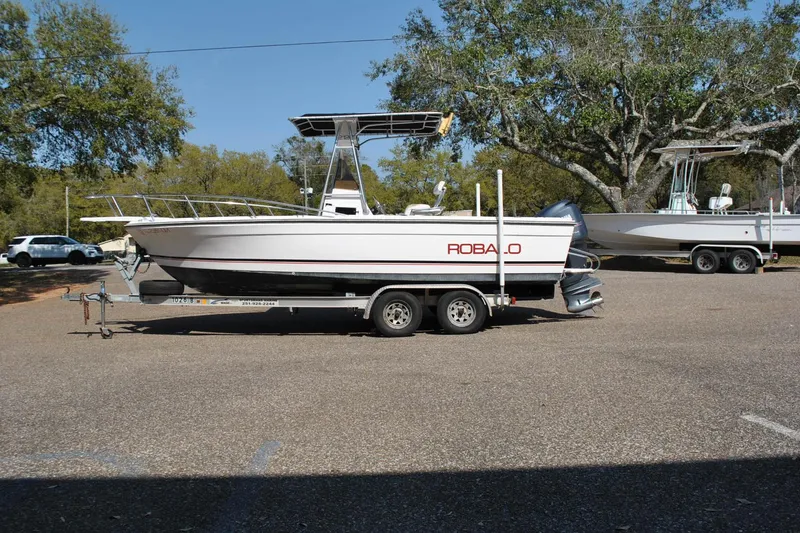 The Image of 1993 Robalo 2120 Center Console boat on trailer, parked outdoors. - 1