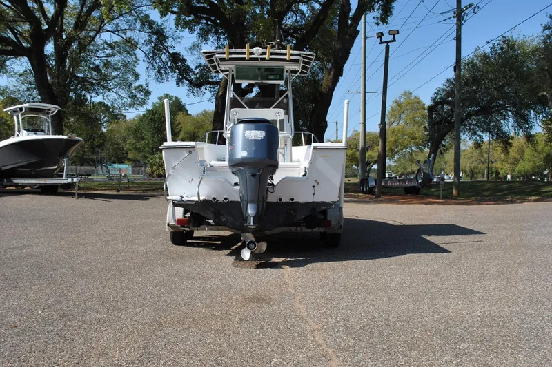 Slide: The Image of 1993 Robalo 2120 Center Console boat with outboard motor, parked outdoors. - 10