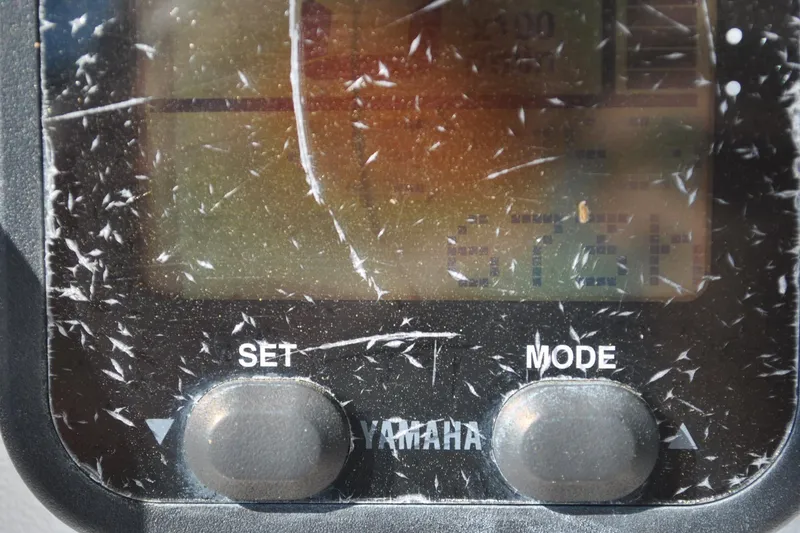 Slide: The Image of Close-up of a scratched Yamaha display on a 1993 Robalo 2120 Center Console boat. - 14