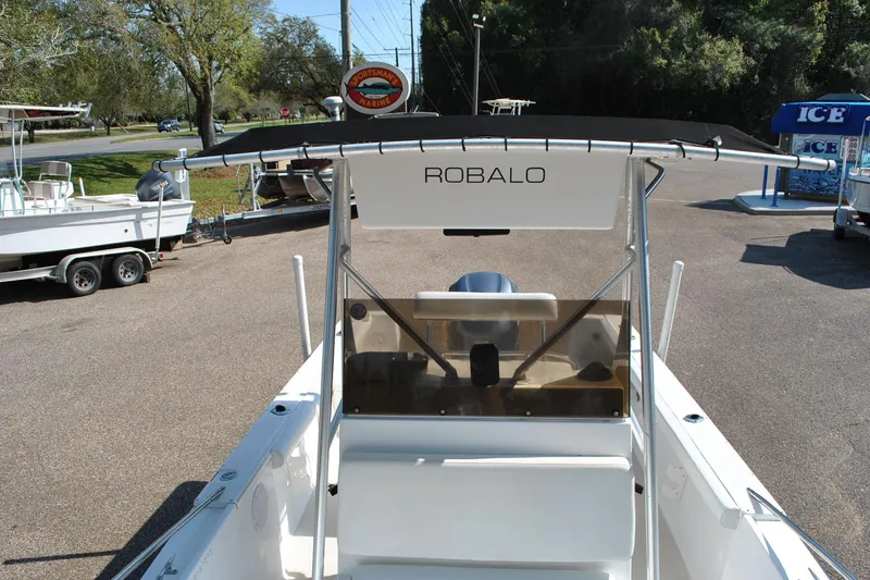 Slide: The Image of 1993 Robalo 2120 Center Console boat with T-top, parked outdoors. - 18
