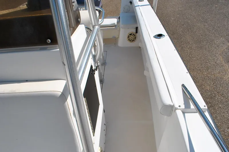 Slide: The Image of 1993 Robalo 2120 Center Console boat interior with white seating and stainless steel railings. - 20