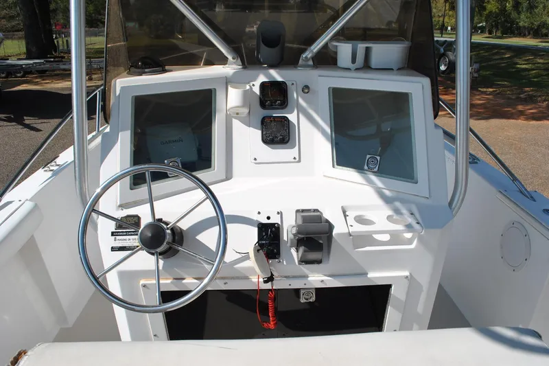 Slide: The Image of 1993 Robalo 2120 Center Console boat dashboard with steering wheel and navigation equipment. - 22