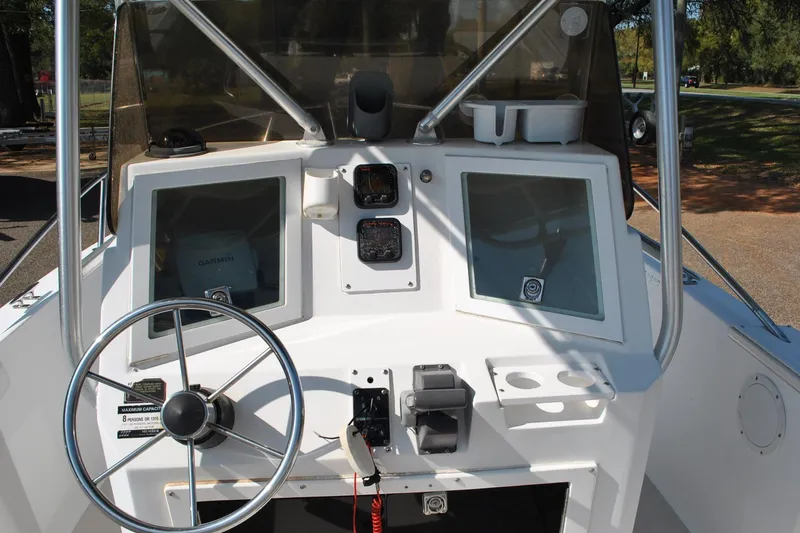 Slide: The Image of 1993 Robalo 2120 Center Console boat dashboard with steering wheel and navigation equipment. - 23