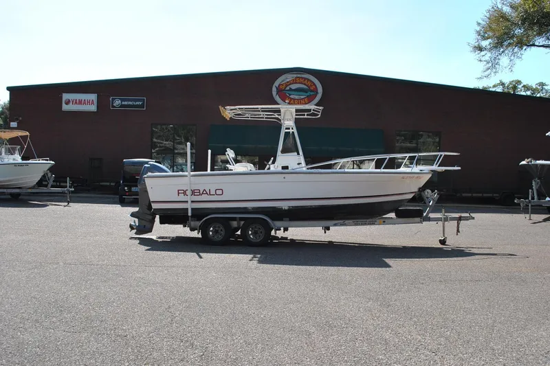 Slide: The Image of 1993 Robalo 2120 Center Console boat on trailer outside marine dealership. - 7