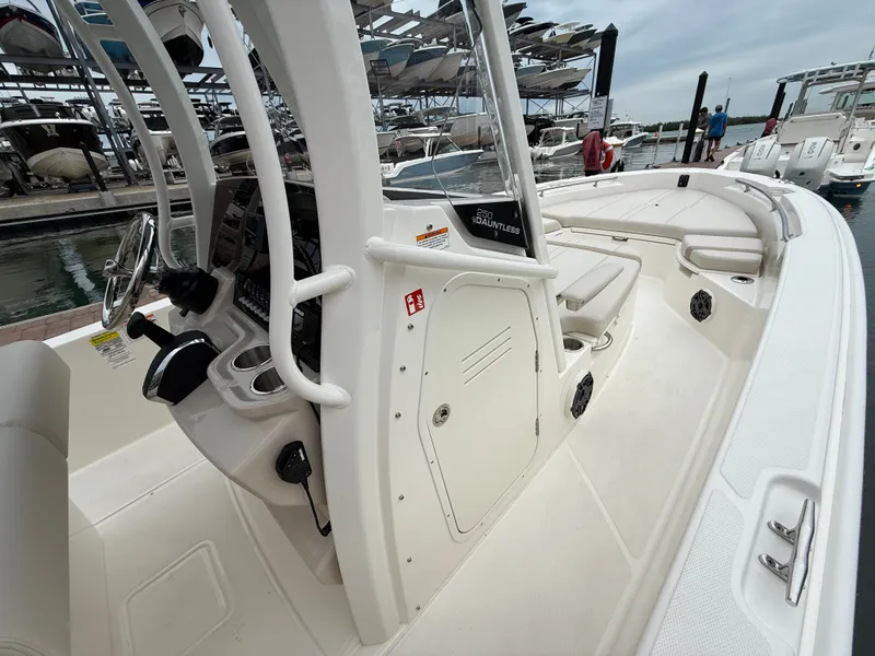 Slide: The Image of Boston Whaler 250 Dauntless 2026 at dock, interior helm view. - 10