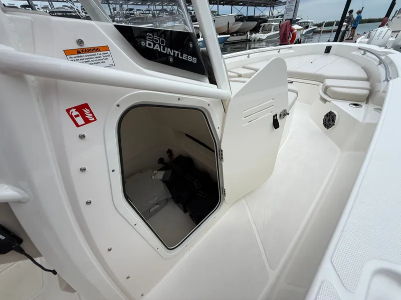Slide: The Image of 2026 Boston Whaler 250 Dauntless with open storage compartment. - 11