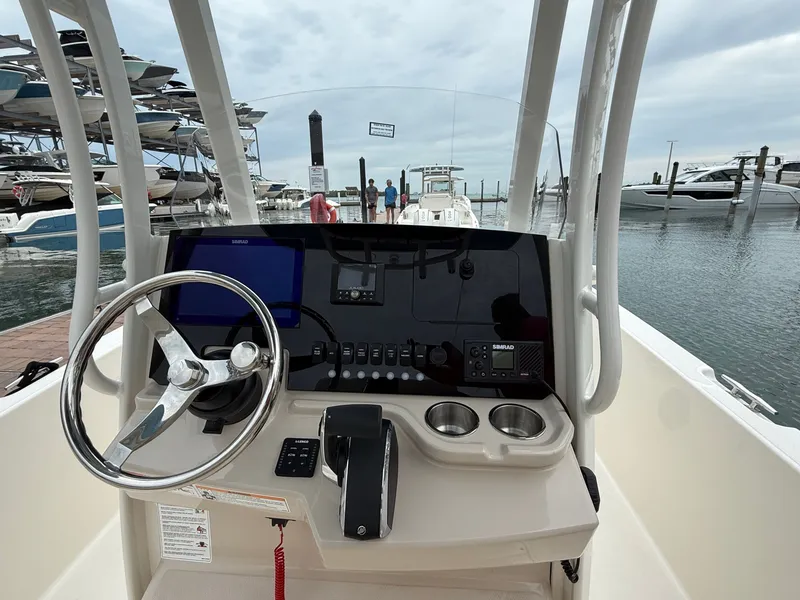 Slide: The Image of Interior view of Boston Whaler 250 Dauntless 2026 cockpit at dock. - 13