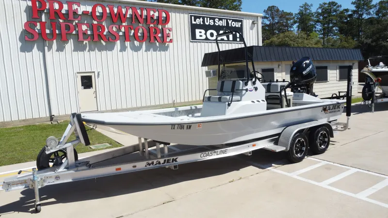 Slide: The Image of 2024 Majek 21RFL boat on trailer outside superstore. - 10
