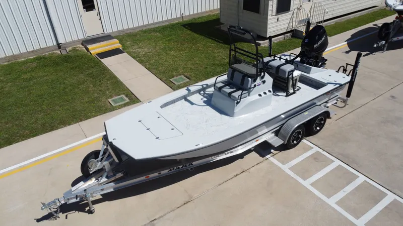 Slide: The Image of 2024 Majek 21RFL boat on trailer in front of building. - 11