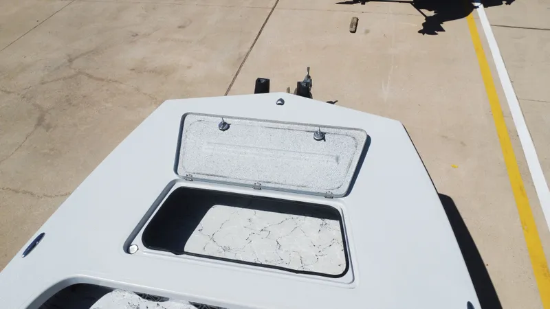 Slide: The Image of 2024 Majek 21RFL boat with open storage compartment on concrete surface. - 28