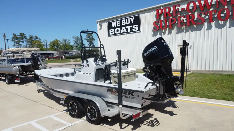 Slide: The Image of 2024 Majek 21RFL boat outside a boat superstore. - 3