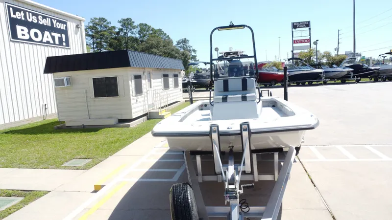 Slide: The Image of 2024 Majek 21RFL boat on trailer outside a sales building. - 9