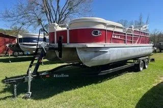 The Image of 2018 Landau Island Breeze 232 Sport Cruise pontoon boat on trailer, parked on grass. - 0