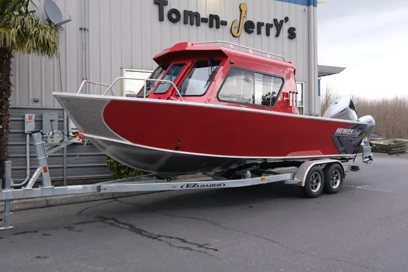 The Image of 2026 Hewescraft 240 Ocean Pro ET Hardtop boat on trailer outside dealership. - 1